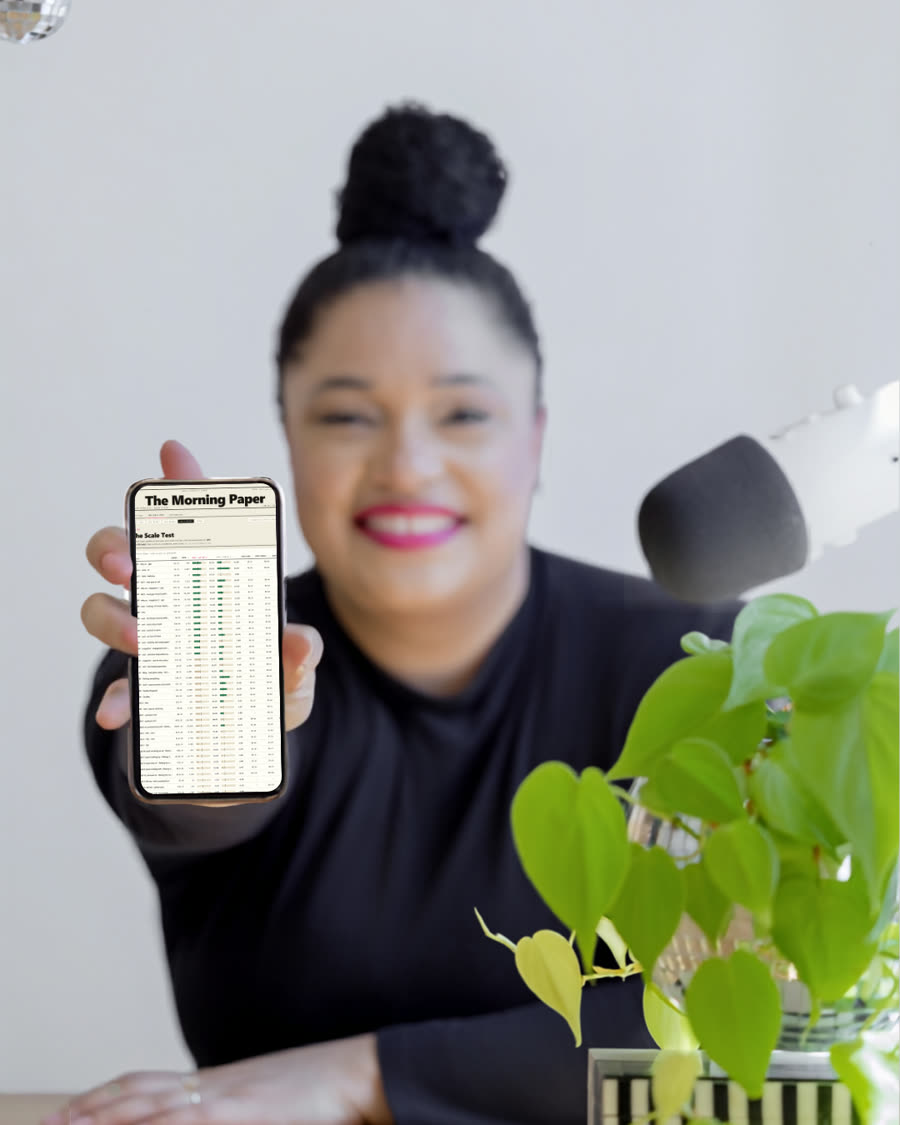 Jillian holding up her phone showing The Morning Paper report